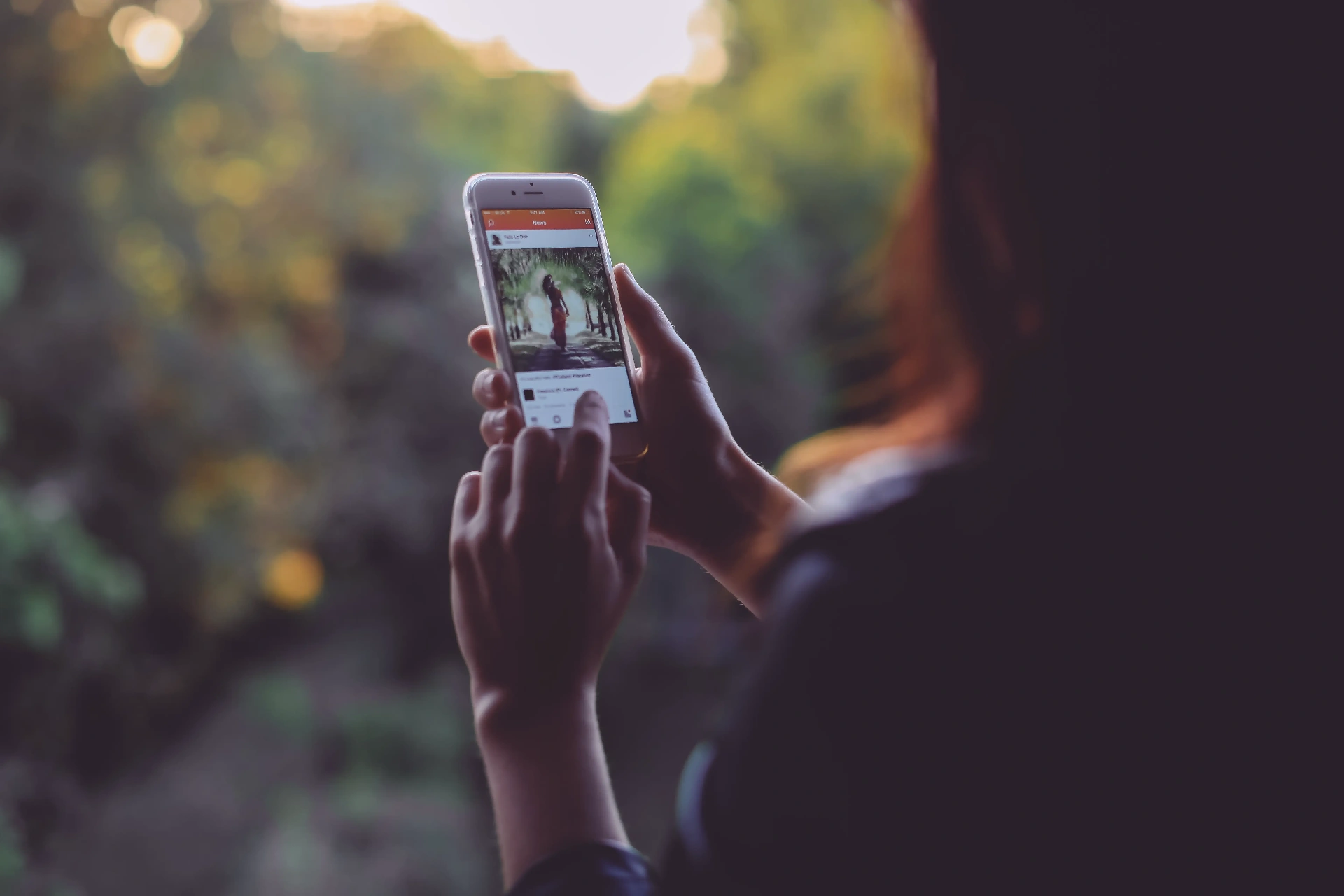 Socialmist news feed shown on an iPhone at golden hour